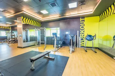 a gym with treadmills and machines in a room at Upgraded 1BR Overlooking Palm Jumeirah & Sea Views from Living to Bedroom, Elite Residence, Dubai Marina by Deluxe Holiday Homes in Dubai