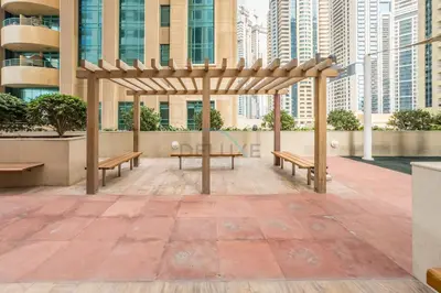 a pavilion in a city with benches and buildings at Upgraded 1BR Overlooking Palm Jumeirah & Sea Views from Living to Bedroom, Elite Residence, Dubai Marina by Deluxe Holiday Homes in Dubai