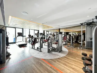 a gym with treadmills and cardio equipment in a building at GuestReady - Luxurious interiors in Business Bay in Dubai