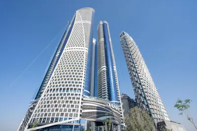 two tall buildings in front of a blue sky at GuestReady - Luxurious interiors in Business Bay in Dubai