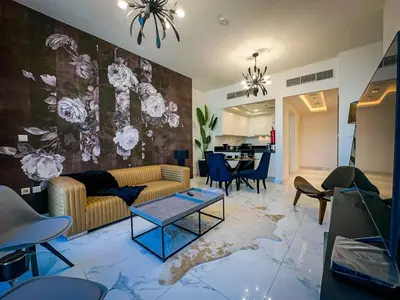 a living room with a couch and a table at Luxury Meets Serenity 2BR Apt in Noura Tower in Dubai