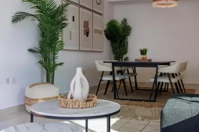 a living room with a table and a dining room at Waterfront flat Stunning view Sleeps 6 in Dubai