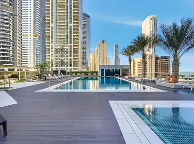 a swimming pool in a city with tall buildings at 1BR Botanica Dubai Marina in Dubai