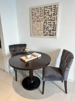 a table and two chairs in a room at Stunning Studio at JVC Damac Ghalia - Msgetaways in Dubai