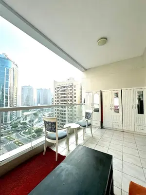 an apartment balcony with a view of a city at Bed in mixed room in Dubai
