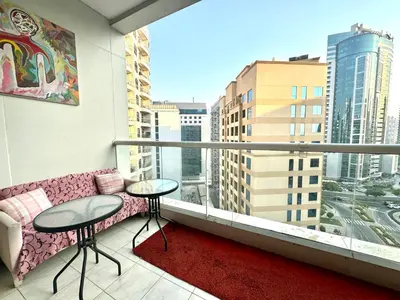 a balcony with a couch and a view of a city at Bed in mixed room in Dubai