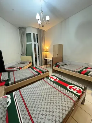 a room with three bunk beds in it at Bed in mixed room in Dubai