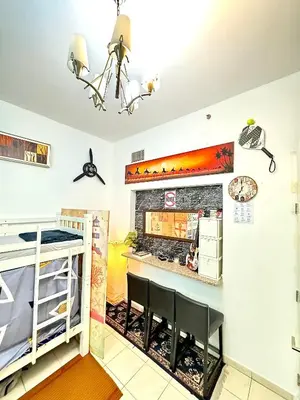 a dining room with a table and a fireplace at Bed in mixed room in Dubai