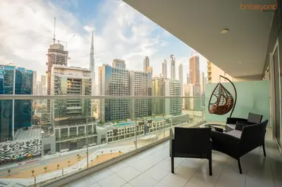 a balcony with a view of a city skyline at Cozy Retreat with Burj Views by Bnbeyond in Dubai