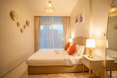 a bedroom with a bed and a window at Cozy Retreat with Burj Views by Bnbeyond in Dubai