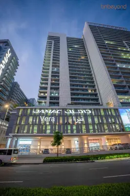 a large building with a sign on the side of it at Cozy Retreat with Burj Views by Bnbeyond in Dubai