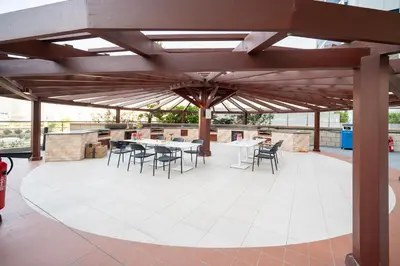 a pavilion with tables and chairs on a patio at 160M2 Modern 2-bedrooms apartment with fantastic views in Dubai