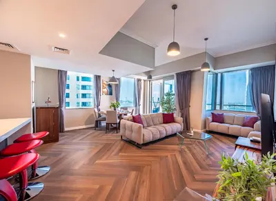 a living room with two couches and a table at 160M2 Modern 2-bedrooms apartment with fantastic views in Dubai