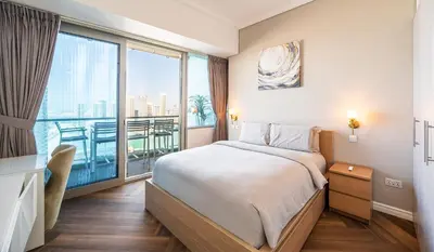 a bedroom with a bed and a large window at 160M2 Modern 2-bedrooms apartment with fantastic views in Dubai