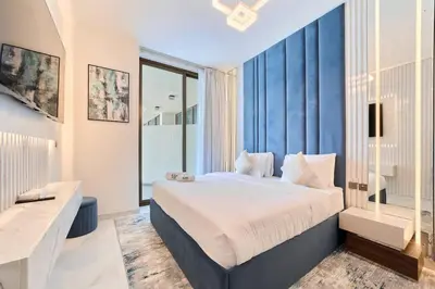 a bedroom with a large bed and a large window at FAM Living - Samana Park Views - Brandnew 1Bed in Dubai