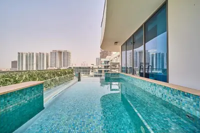 a swimming pool on the roof of a building at FAM Living - Samana Park Views - Brandnew 1Bed in Dubai