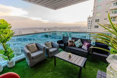 a balcony with couches and a pool on a building at New Elegant & Luxury 3BR Apartment In Dubai Marina in Dubai
