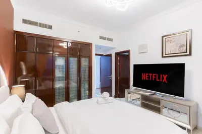 a hotel room with a bed and a television at New Elegant & Luxury 3BR Apartment In Dubai Marina in Dubai