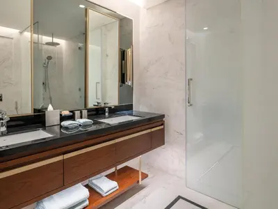 a bathroom with a sink and a shower at Cheval Maison - Expo City Dubai in Dubai