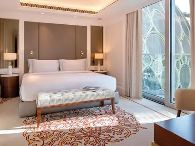 a bedroom with a bed and a large window at Cheval Maison - Expo City Dubai in Dubai