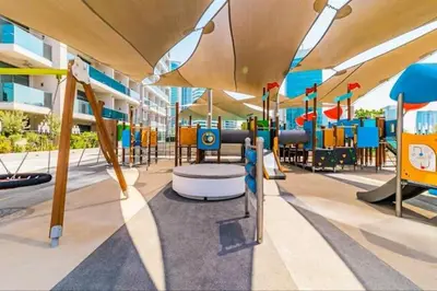 a playground with a slide and chairs in a building at Vogue Downtown Mag 318 near Burj Khalifa and Dubai Mall, Studio Apartment with Balcony, Canal and City View, Access to all Amenities in Dubai