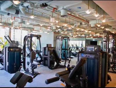 a gym with several treadmills and cardio machines at Vogue Downtown Mag 318 near Burj Khalifa and Dubai Mall, Studio Apartment with Balcony, Canal and City View, Access to all Amenities in Dubai