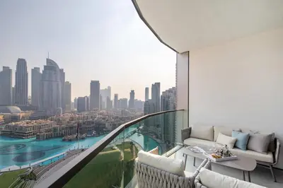 a room with a balcony with a view of a city at Frank Porter - Grande Signature Residences in Dubai