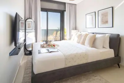 a bedroom with a large bed with a large window at Frank Porter - Aykon City Tower C in Dubai