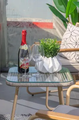 a bottle of wine and two wine glasses on a table at Frank Porter - Aykon City Tower C in Dubai