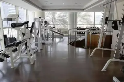 a gym with treadmills and machines in a room at Cozy 1bd near JBR Beach in Dubai