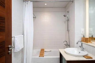 a bathroom with a white tub and a sink at Cozy 1bd near JBR Beach in Dubai