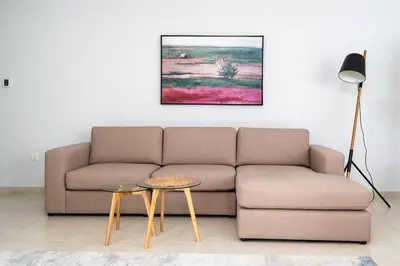 a living room with a couch and a table at Cozy 1bd near JBR Beach in Dubai