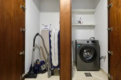 a laundry room with a washer and a washing machine at Cozy 1bd near JBR Beach in Dubai