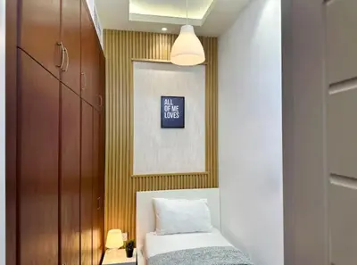 a bedroom with a bed and a painting on the wall at Destination Partition Room in Tecom Near Metro in Dubai