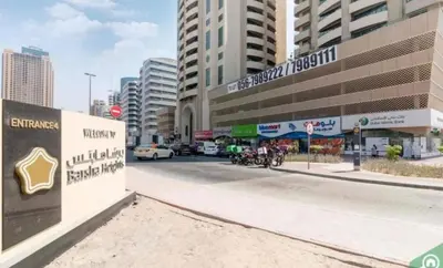 a street in a city with buildings and cars at Destination Partition Room in Tecom Near Metro in Dubai