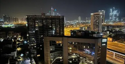 a view of a city at night with buildings at Destination Partition Room in Tecom Near Metro in Dubai