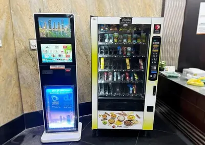 a drink vending machine with a tablet next to it at Elegance Partition Room in Tecom Near ICM Metro in Dubai