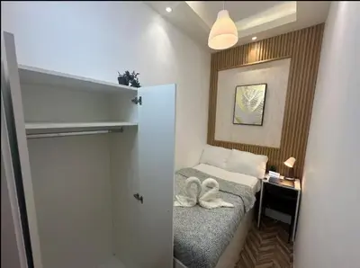 a small room with a bed with swans on it at Beautiful Partition Room in Barsha heights in Dubai