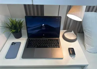 a laptop computer sitting on top of a desk at Beautiful Partition Room in Barsha heights in Dubai
