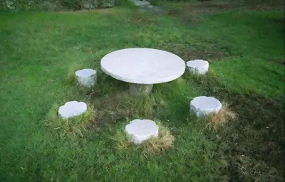 a white table in the middle of a field with rocks around it at Attraction Partition Room in Barsha heights Tecom in Dubai