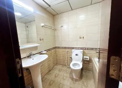 a bathroom with a toilet and a sink at Center Point Partition Room in Tecom in Dubai