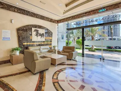 a living room with a couch and chairs in a building at Perfect Marina Stay - Ideal for great Holidays in Dubai