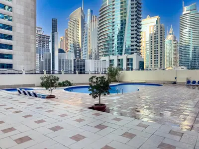 a pool in the middle of a city with tall buildings at Perfect Marina Stay - Ideal for great Holidays in Dubai