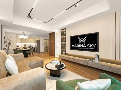 a living room with a large tv on a wall at SKY HIGH 2 BHK # Ain Dubai & Sea View # Marina & JBR in Dubai