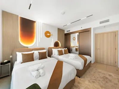 two beds in a hotel room with white and brown at SKY HIGH 2 BHK # Ain Dubai & Sea View # Marina & JBR in Dubai