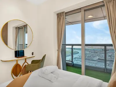 a bedroom with a bed and a large window at SKY HIGH 2 BHK # Ain Dubai & Sea View # Marina & JBR in Dubai