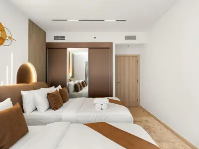 a hotel room with two beds and a mirror at SKY HIGH 2 BHK # Ain Dubai & Sea View # Marina & JBR in Dubai