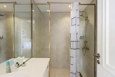 a bathroom with a shower and a sink at Livbnb - Homey 1B with Spacious Terrace in District 14, JVC in Dubai