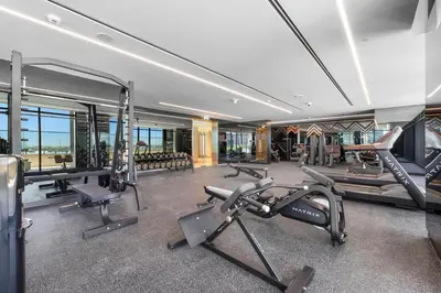 a gym with several exercise equipment in a building at LUX 2BR in Missoni Tower - 5 mins to Burj Khalifa in Dubai