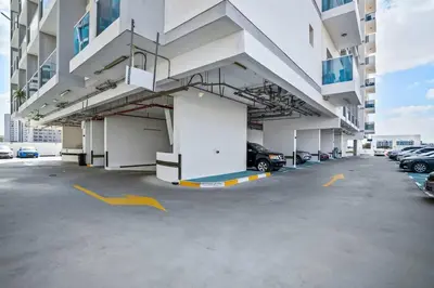 a parking lot of a building with cars parked at Newly Built Studio - Urban Living in Dubai
